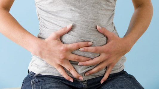woman holding her bloated stomach